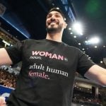 Former NBA center Enes Kanter Freedom greets a friend before a WNBA basketball game between the Indiana Fever and the