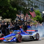 IndyCar Series driver David Malukas drives a race car down West Executive Drive during an event with President Donald Trump