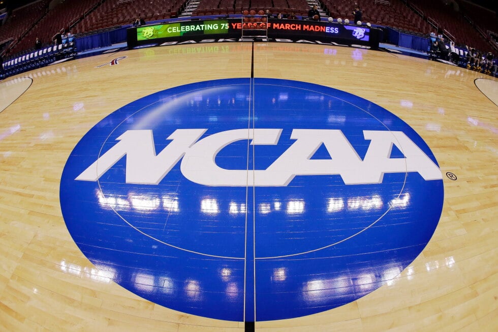 This photo taken with a fisheye lens shows the NCAA logo displayed at mid-court in Philadelphia, March 21, 2013. (AP