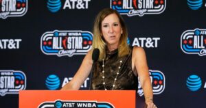 WNBA Commissioner Cathy Engelbert stands at a podium and talks to media before the WNBA All-Star Game on July 25