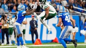 New York Jets tight end Kenyon Sadiq (16) runs against Detroit Lions cornerback D.J. Reed (4) during the second half at Ford