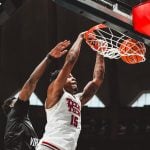 JT Toppin throws down a dunk on a West Virginia defender