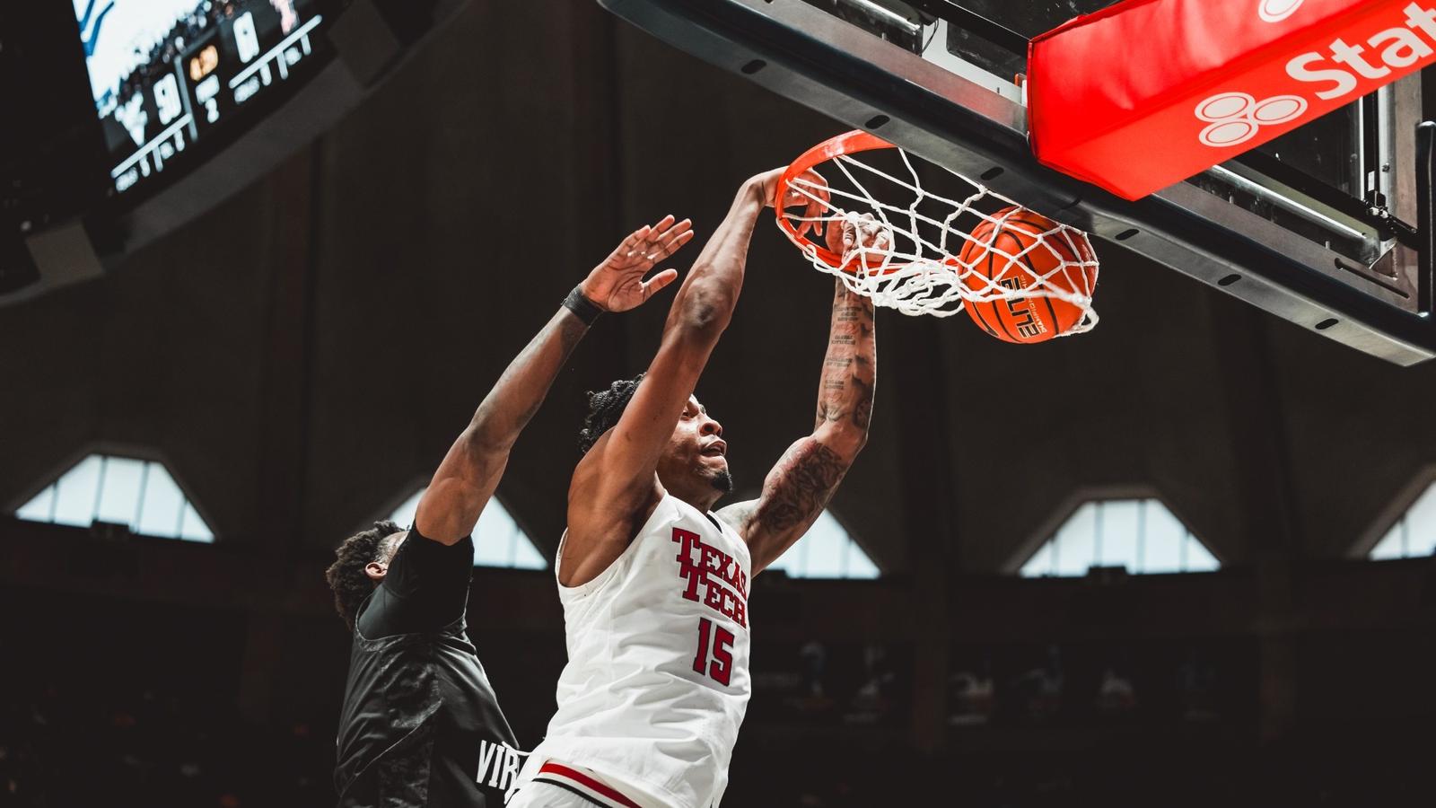 JT Toppin throws down a dunk on a West Virginia defender
