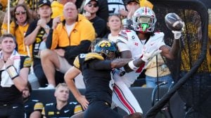 Ohio State Buckeyes wide receiver Jeremiah Smith (4) is hit by Iowa Hawkeyes wide receiver Evan James (8) as he attempts a