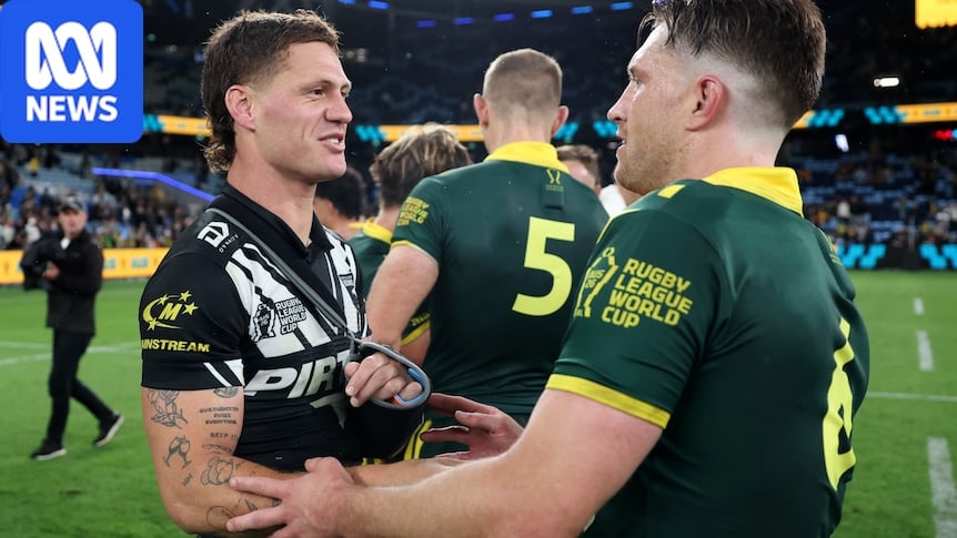 Two players embrace after a game, one player with arm in sling